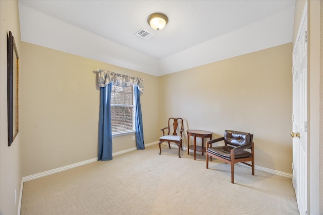 sitting room featuring light carpet, visible vents, and baseboards