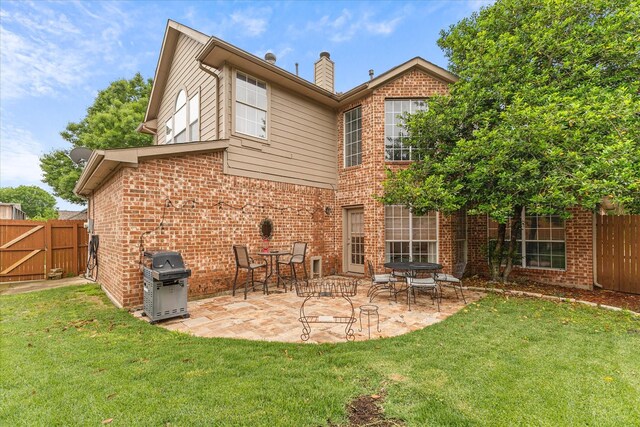 619 Loch View Ct, Rockwall, TX 75087 - rear view of house with brick siding, a patio area, and a chimney