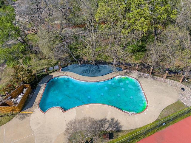 pool featuring a patio area and fence