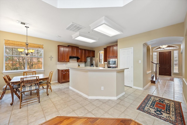 619 Loch View Ct, Rockwall, TX 75087 - kitchen with stainless steel appliances, arched walkways, a chandelier, light tile patterned floors, and light countertops