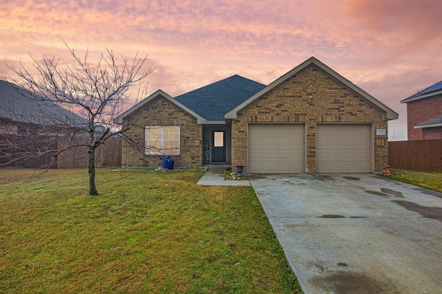 ranch-style home featuring concrete driveway, brick siding, and a yard