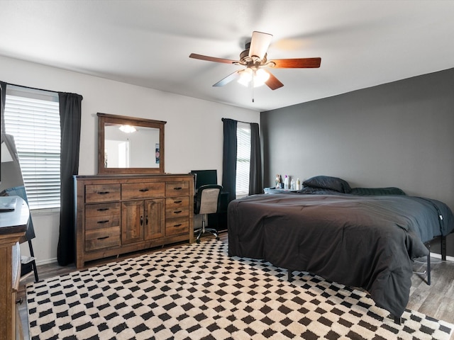 bedroom with ceiling fan and baseboards