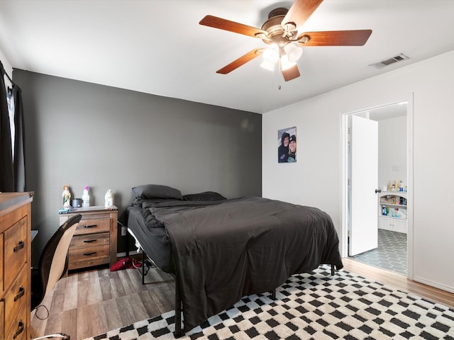 bedroom with a ceiling fan, visible vents, and light wood-style floors