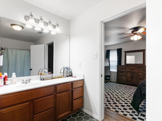 full bath with visible vents, baseboards, vanity, and a ceiling fan