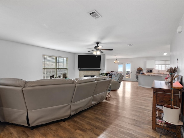 living room with a healthy amount of sunlight, visible vents, and wood finished floors