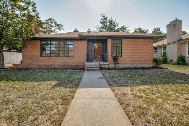 view of front of home featuring a front yard and brick siding