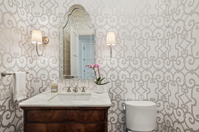 half bath featuring toilet and vanity