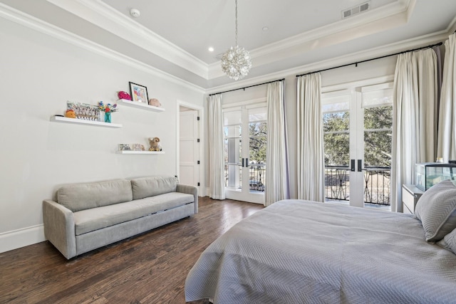 bedroom featuring visible vents, a raised ceiling, dark wood finished floors, access to outside, and french doors