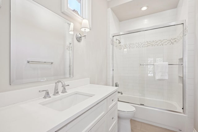 bathroom with shower / bath combination with glass door, recessed lighting, toilet, vanity, and tile patterned floors