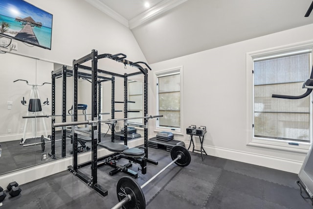 workout area featuring crown molding, vaulted ceiling, and baseboards