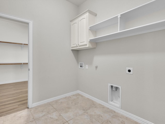 laundry area featuring cabinet space, baseboards, hookup for a gas dryer, hookup for a washing machine, and electric dryer hookup