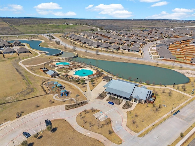 bird's eye view featuring a water view and a residential view