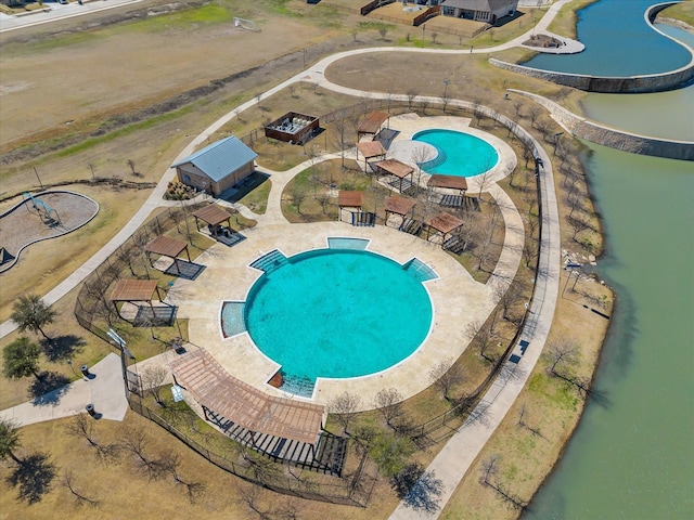 community pool with a water play area and a patio