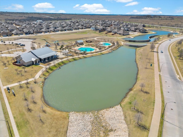 drone / aerial view with a water view and a residential view