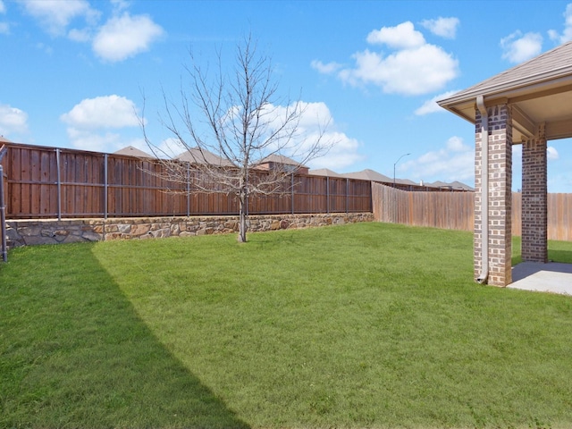 view of yard with a fenced backyard