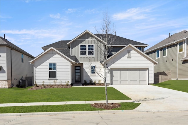 view of front of home with board and batten siding, a front yard, concrete driveway, and an attached garage