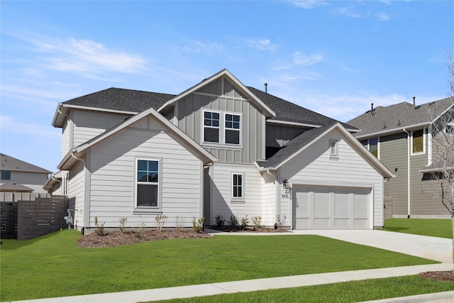 view of front of home with board and batten siding, a garage, a front lawn, and concrete driveway