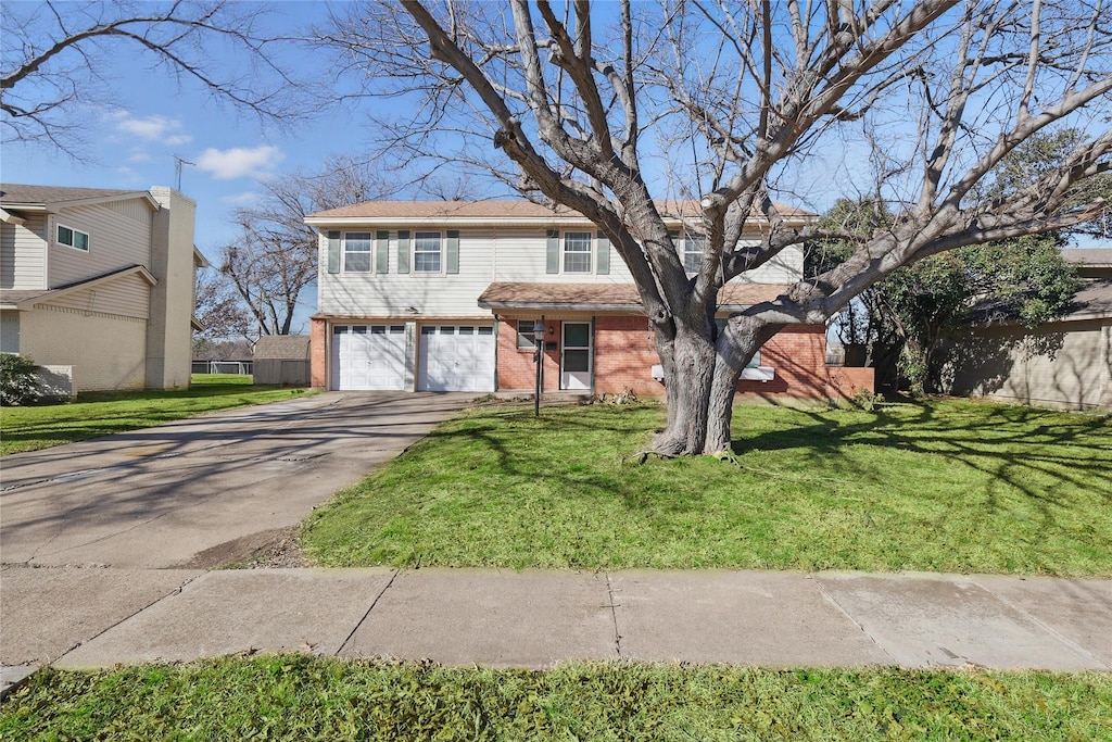 view of front facade with driveway, a garage, a front lawn, and brick siding