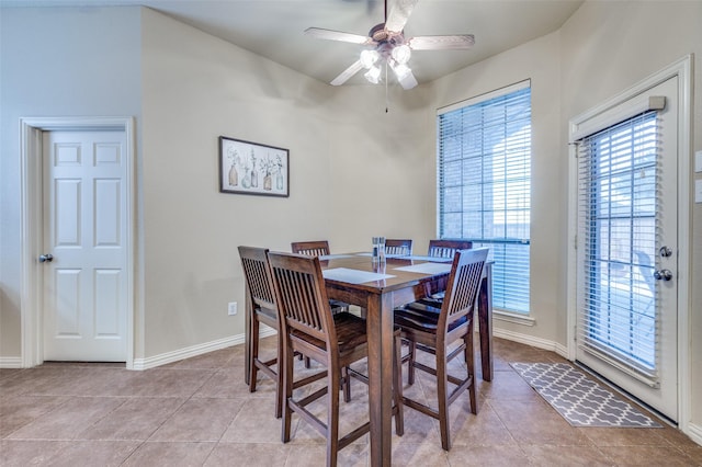 dining room featuring light tile patterned floors, a ceiling fan, and baseboards