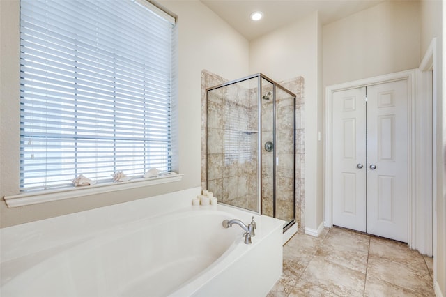 full bath with a stall shower, tile patterned flooring, and a garden tub