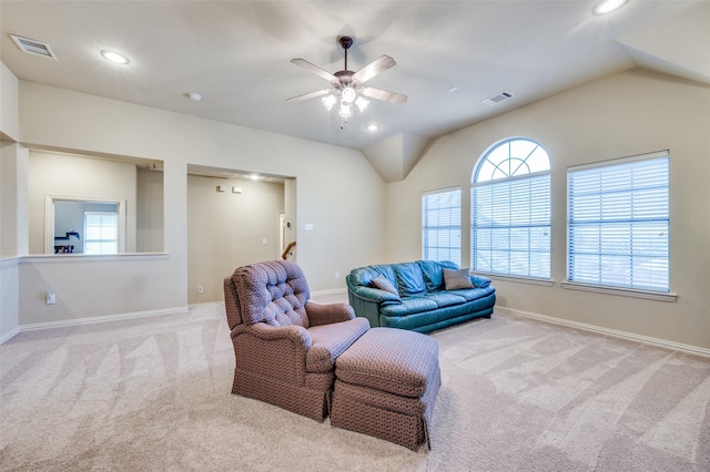 living room featuring visible vents, vaulted ceiling, light carpet, and baseboards