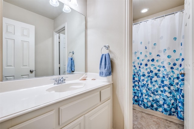 full bath with curtained shower, tile patterned flooring, and vanity