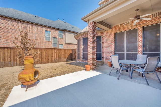 view of patio featuring outdoor dining space, a fenced backyard, and ceiling fan