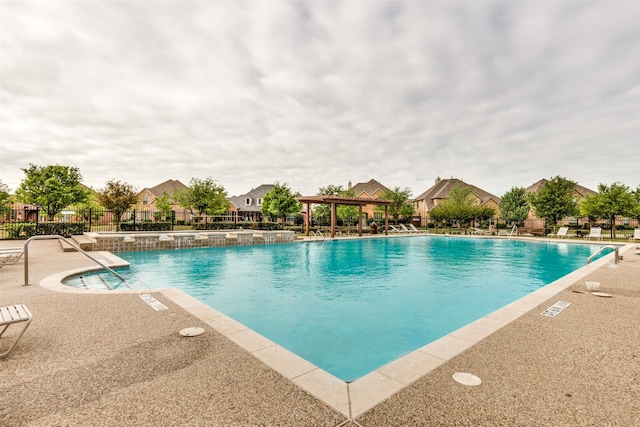 pool featuring a residential view, a patio area, fence, and a gazebo