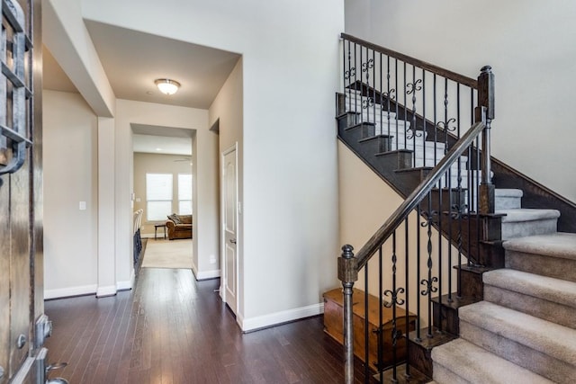 stairway featuring baseboards and wood finished floors