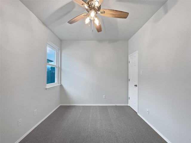 unfurnished room with dark colored carpet, ceiling fan, and baseboards