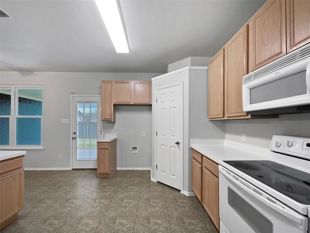 kitchen featuring light countertops, white appliances, visible vents, and baseboards