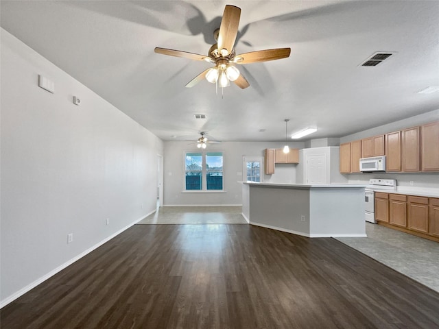 kitchen featuring white appliances, visible vents, open floor plan, light countertops, and pendant lighting