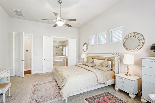 bedroom with visible vents, a ceiling fan, light carpet, ensuite bath, and baseboards