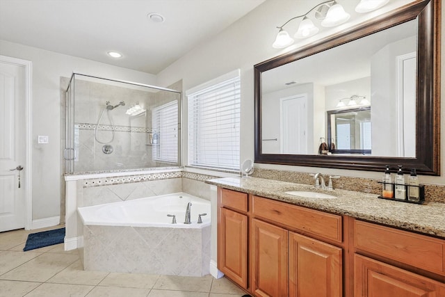 bathroom featuring a stall shower, vanity, a bath, and tile patterned floors