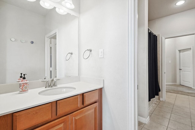 full bathroom with vanity, baseboards, and tile patterned floors