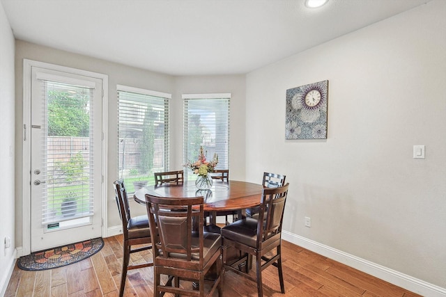 dining area featuring baseboards and wood finished floors