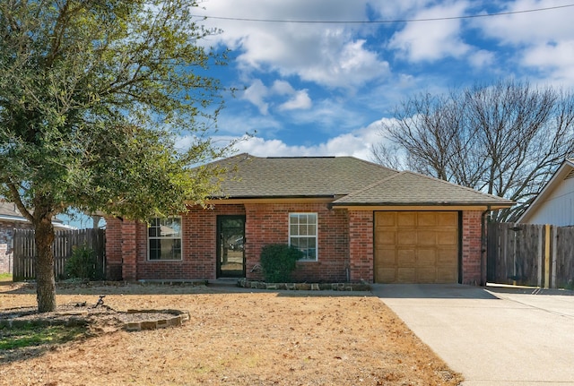 ranch-style home with driveway, brick siding, and fence