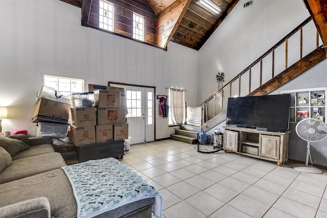 tiled living area featuring visible vents, wooden ceiling, stairway, french doors, and high vaulted ceiling