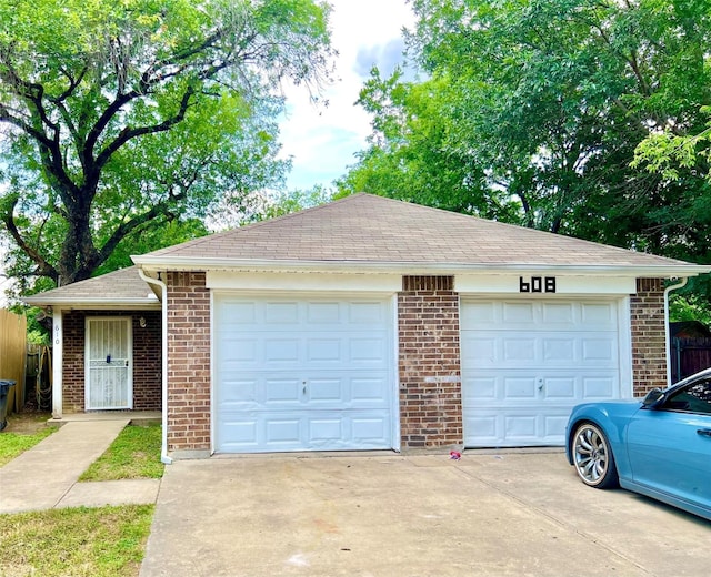 garage with concrete driveway