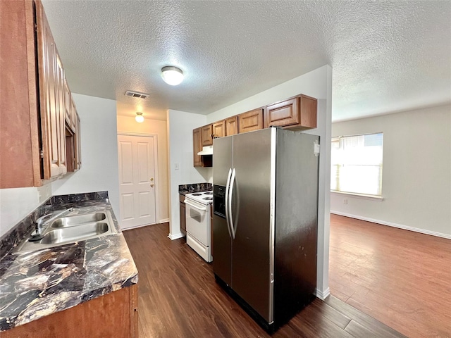 kitchen featuring brown cabinets, white electric range oven, visible vents, a sink, and stainless steel fridge with ice dispenser