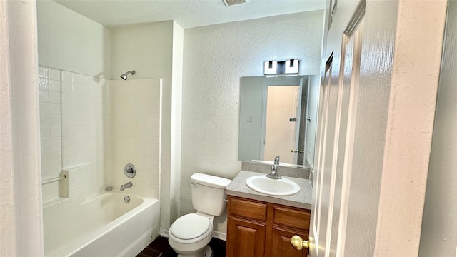 bathroom with shower / bath combination, a textured wall, vanity, and toilet