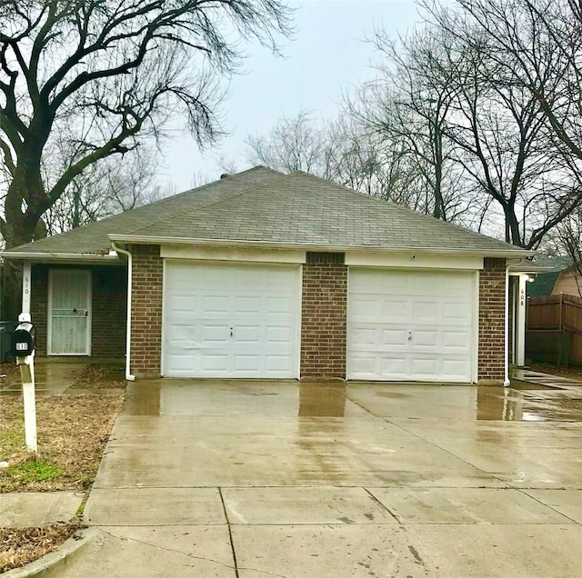 garage featuring concrete driveway