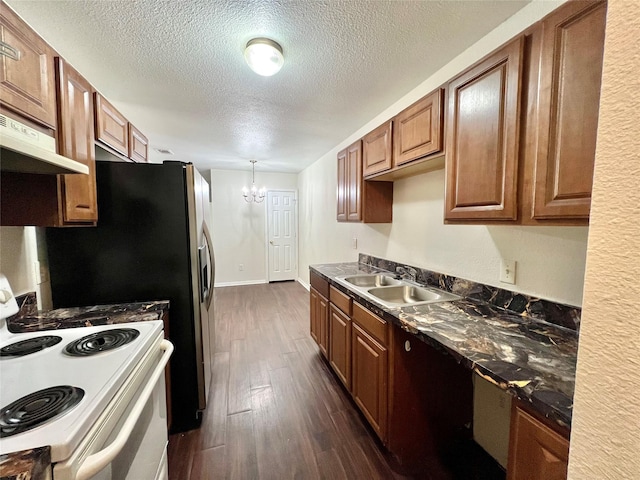 kitchen featuring white range with electric stovetop, dark wood finished floors, brown cabinetry, a sink, and under cabinet range hood