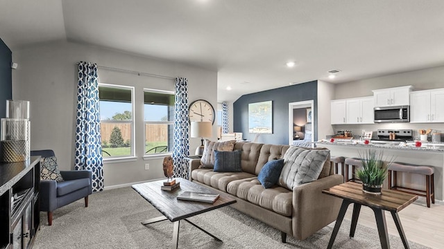 living room with recessed lighting, visible vents, and baseboards