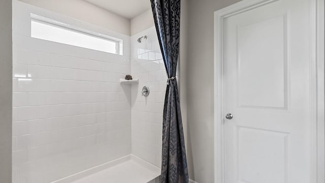 bathroom with a tile shower