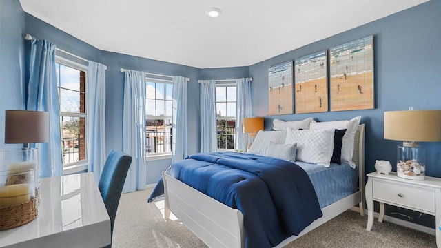 bedroom with baseboards and light colored carpet