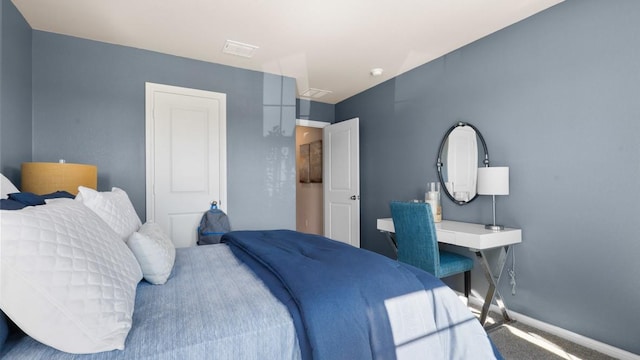 bedroom with carpet, visible vents, and baseboards