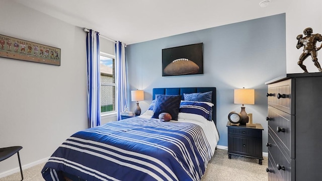 bedroom with light carpet and baseboards