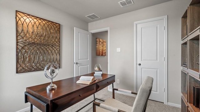 office space featuring visible vents, light carpet, and baseboards