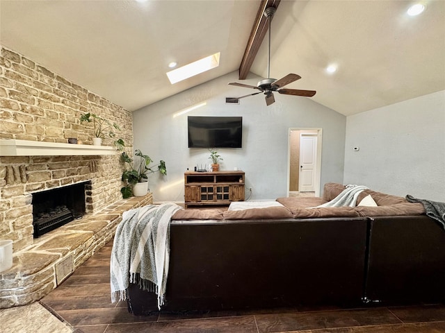 living area with dark wood finished floors, recessed lighting, lofted ceiling with skylight, a ceiling fan, and a large fireplace